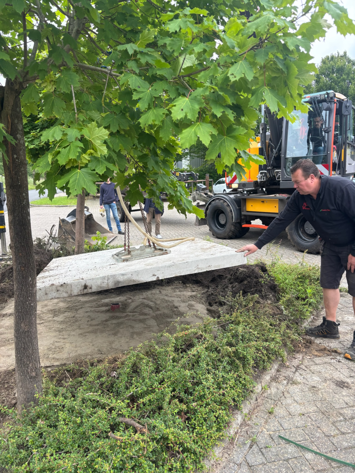 Plaatsing van een betonnen fundatieplaat op het erf